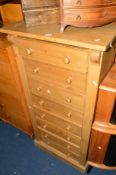 A PINE WELLINGTON CHEST of eight drawers, approximate size width 61cm x depth 37cm x height 130cm