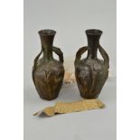 A PAIR OF LATE 19TH/EARLY 20TH CENTURY BRONZED METAL TWIN HANDLED VASES, cast in relief with arum