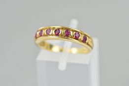 A 9CT GOLD RUBY HALF ETERNITY RING, set with seven circular rubies, hallmark rubbed, ring size M,