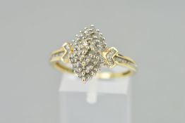 A 9CT GOLD DIAMOND DRESS RING, the tiered central panel set with single cut diamonds, the arrow