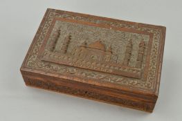 A FIRST HALF 20TH CENTURY CARVED OAK WORK BOX, the hinged cover decorated in relief with a titled