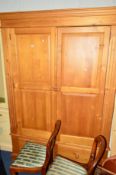 A LARGE PINE TWO DOOR WARDROBE above two drawers, approximate width 145cm x depth 58cm x height