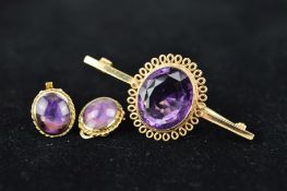 A LATE 20TH CENTURY AMETHYST BAR BROOCH, a large oval mixed cut amethyst measuring approximately