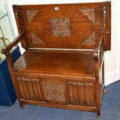 AN OAK LINENFOLD MONKS BENCH with a hinged lid