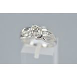 A MODERN PLATINUM DIAMOND RING, centring on a principle modern round brilliant cut diamond,