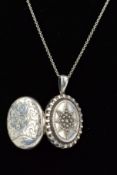 A MID VICTORIAN SILVER LOCKET AND LATER CHAIN, of oval outline with central embossed star to the