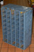 A METAL SHELVING UNIT OF FORTY DIVISIONS, painted grey, height 86cm x width 60.5cm x depth 30cm (