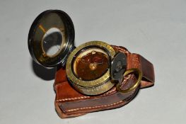 A WHITING EXCHANGE MANCHESTER LIQUID FILLED POCKET COMPASS, with leather pouch, fluid has tainted