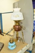 A BRASS AND COPPER OIL LAMP, with intact glass shade and chimney, height approximately 60cm , by