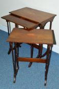 AN EDWARDIAN MAHOGANY AND INLAID NEST OF THREE TABLES, on slender turned column supports, shaped