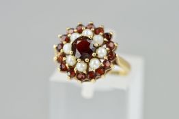 A MID TO LATE 20TH CENTURY SEED PEARL AND GARNET ROUND CLUSTER RING, ring size K1/2, hallmarked