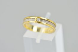 AN 18CT GOLD DIAMOND BAND RING, designed as a channel with textured white gold inner band and yellow