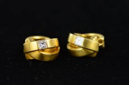 A PAIR OF 18CT GOLD DIAMOND EARRINGS, the hinged hoop earrings of crossover design, each set with