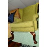 A GREEN UPHOLSTERED WING BACK CHAIR