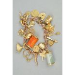 A 9CT GOLD CHARM BRACELET, the curb link chain suspending twenty one charms to include a thistle and