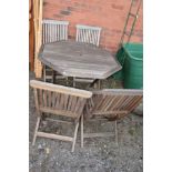 A TEAK GARDEN TABLE and four folding chairs (5)