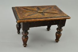 A LATE VICTORIAN RECTANGULAR OAK FOOTSTOOL, flower head design carved to the top, on four turned