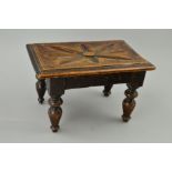 A LATE VICTORIAN RECTANGULAR OAK FOOTSTOOL, flower head design carved to the top, on four turned