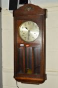A MID 20TH CENTURY OAK WALL CLOCK (key and pendulum)