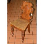 A VICTORIAN OAK HALL CHAIR, the cartouche shaped back with panel seat, on turned front legs (