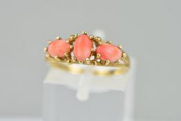 A LATE 20TH CENTURY THREE STONE CORAL DRESS RING, ring size M1/2, approximate gross weight 2.1