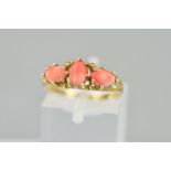 A LATE 20TH CENTURY THREE STONE CORAL DRESS RING, ring size M1/2, approximate gross weight 2.1