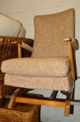 A MID CENTURY UPHOLSTERED ROCKING CHAIR