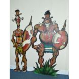 TWO PLYWOOD THEATRE PROPS IN THE FORM OF TWO COMICAL TRIBAL WARRIORS, painted with bones through