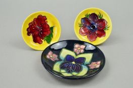 THREE MOORCROFT POTTERY TRINKET DISHES, 'Anemone' and 'Hibiscus', both on yellow ground, diameters