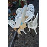 A WHITE PAINTED CAST ALUMINIUM GARDEN TABLE, four chairs and a parasol (6)