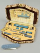 A 1930'S CASED MANICURE SET, containing matched items (under end cabinet in hallway)