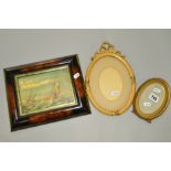 TWO OVAL GILT PICTURE FRAMES, together with a reproduction oil on canvas of fishing boats at sea (