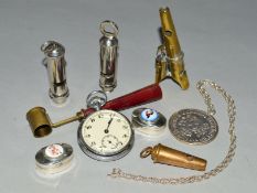 A BAG OF COLLECTABLES INCLUDING FOUR WHISTLES, one with three notes, a brass powder measure, a