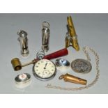 A BAG OF COLLECTABLES INCLUDING FOUR WHISTLES, one with three notes, a brass powder measure, a