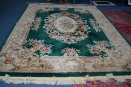 A WOOLLEN CHINESE CARPET SQUARE, green ground and foliate design, approximate size 368cm x 274cm