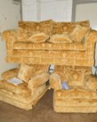 A GOLD FLORAL UPHOLSTERED THREE PIECE LOUNGE SUITE