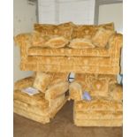 A GOLD FLORAL UPHOLSTERED THREE PIECE LOUNGE SUITE