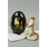 A RENAISANCE CHINA FIGURE OF AN OTTER, together with an egg (Spanish marble) painted of an otter,