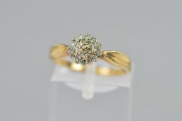 A 9CT GOLD DIAMOND CLUSTER RING, the circular cluster designed as three tiers of single cut