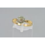 A 9CT GOLD DIAMOND CLUSTER RING, the circular cluster designed as three tiers of single cut