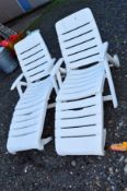 A PAIR OF WHITE UPVC GARDEN LOUNGERS