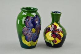 TWO SMALL MOORCROFT POTTERY VASES, 'Clematis' pattern on green ground, approximate height 10.5cm and
