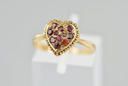A GARNET RING, designed as a heart shape panel set with circular garnets, stamped 9ct, ring size
