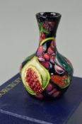 A SMALL BOXED MOORCROFT POTTERY BUD VASE, 'Queens Choice' pattern, designed by Emma Bossons,