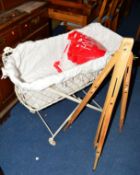 A PAINTED VICTORIAN WROUGHT IRON FOLDING COT on ceramic casters and an artists easel