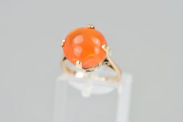 A CARNELIAN RING, the cabochon carnelian claw set to the tapered plain band, stamped 9ct, ring