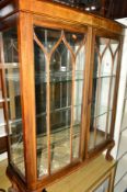 A WALNUT GLAZED TWO DOOR CHINA CABINET on ball and claw feet (key)
