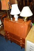 A TEAK FALL FRONT BUREAU, a yew wood serpentine chest of four drawers, an oak magazine rack, desk