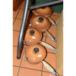 A SET OF FOUR GRADUATING LE CREUSET BROWN SAUCEPANS (well used)