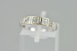 A DIAMOND DRESS RING, designed as four square panels set with four princess cut diamonds and a